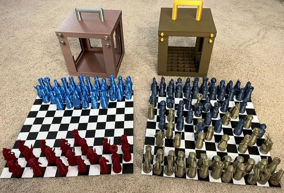 Both sets unpacked — four armies on two boards, the empty boxes standing guard behind.